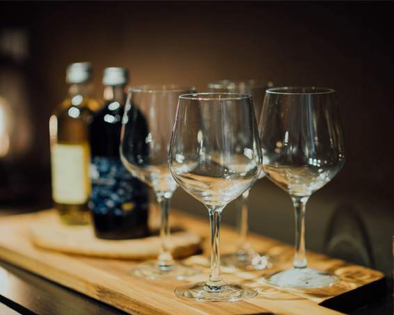 wooden cutting board with wine glasses on it