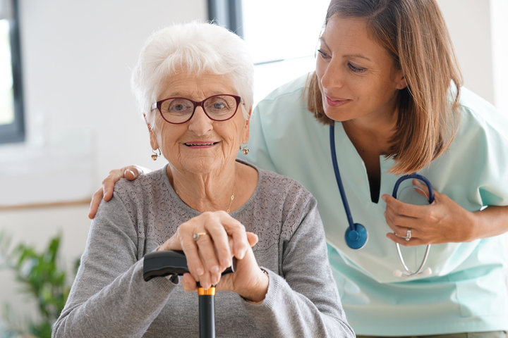nurse and older person in care home