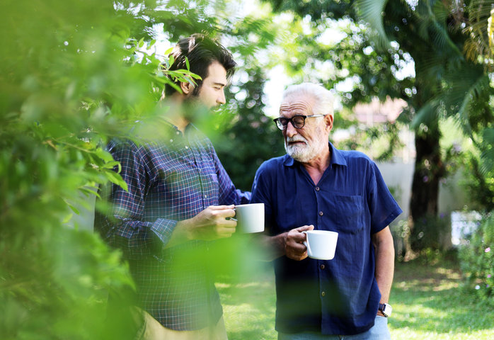 son and father stalking about care in the garden