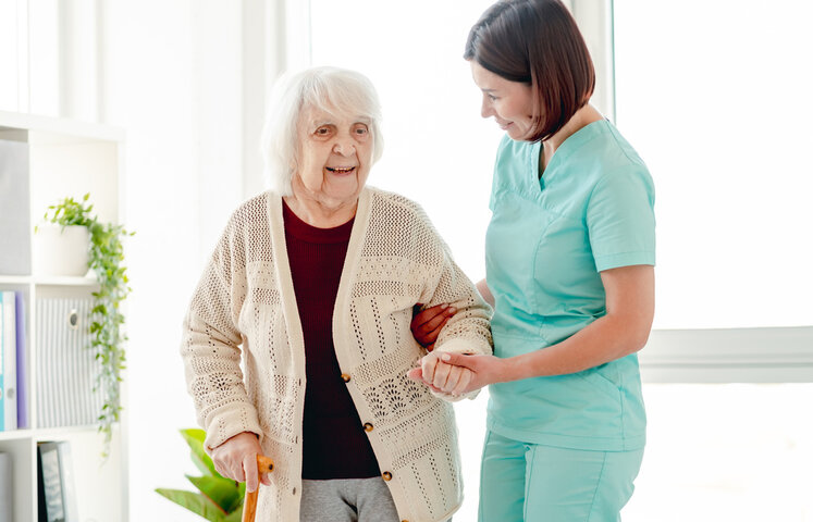 nurse and older person in care home