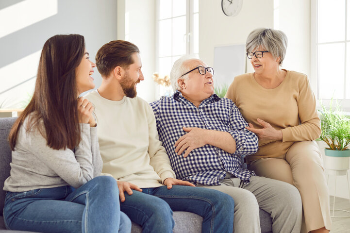 family smiling on sofa
